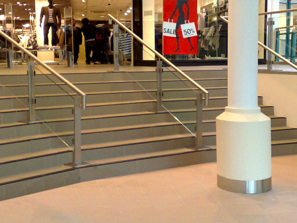 retail staircase with banister and glass